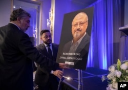 FILE - An image of slain Saudi journalist Jamal Khashoggi is set up before a memorial event in Washington, Nov. 2, 2018.