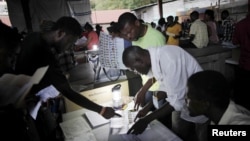 Electoral workers revise ballot papers during vote counting in Port-au-Prince, Haiti, August 9, 2015.