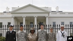 Service members stand together after they handcuffed themselves to the fence outside the White House in Washington during a protest for gay rights, 16 April 2010 (file photo)