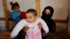 Syrian refugee Asheqa holds her unregistered baby daughter Nour inside a tent at a refugee camp near the town of Baalbek in Lebanon's Bekaa valley, March 3, 2016. 