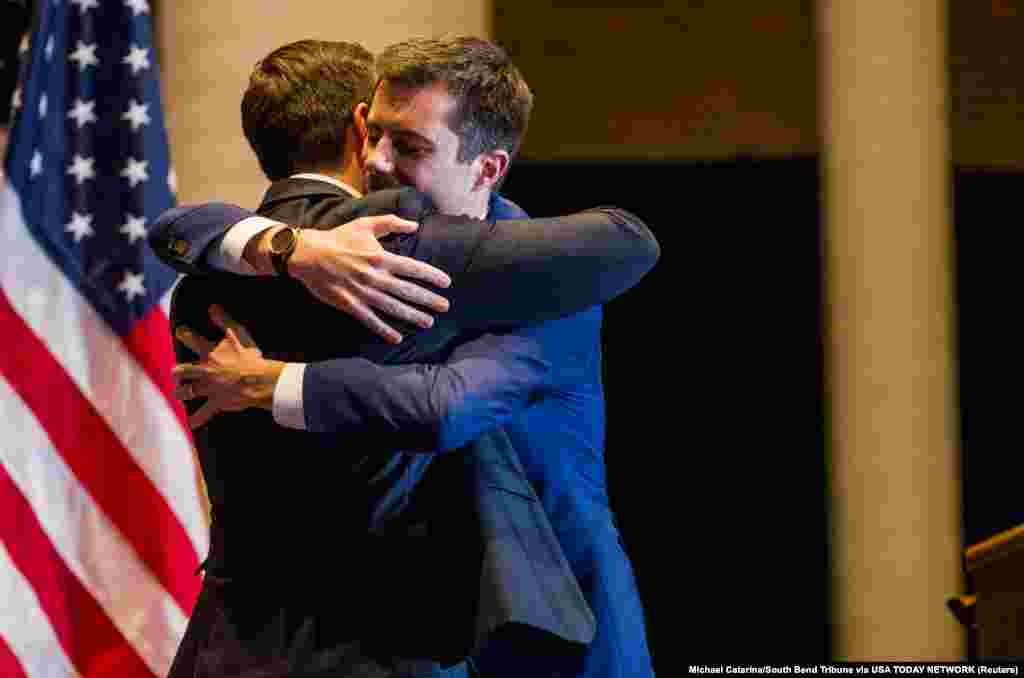 Democratic U.S. presidential candidate Pete Buttigieg hugs his husband Chasten Buttigieg as he arrives to announce his withdrawal from the race for the 2020 Democratic presidential nomination during an event in South Bend, Indiana, March 1, 2020.