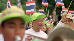 Former Thai Prime Minister Anand Panyarachun, center, marches at a rally where thousands celebrated the completion of a draft charter for a new constitution at Democracy Monument in Bangkok Sunday, Aug. 17, 1997.