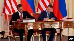 FILE - President Barack Obama, left, and Russian president Dmitry Medvedev sign the New START treaty at the Prague Castle in Prague in this, April 8, 2010 file photo.