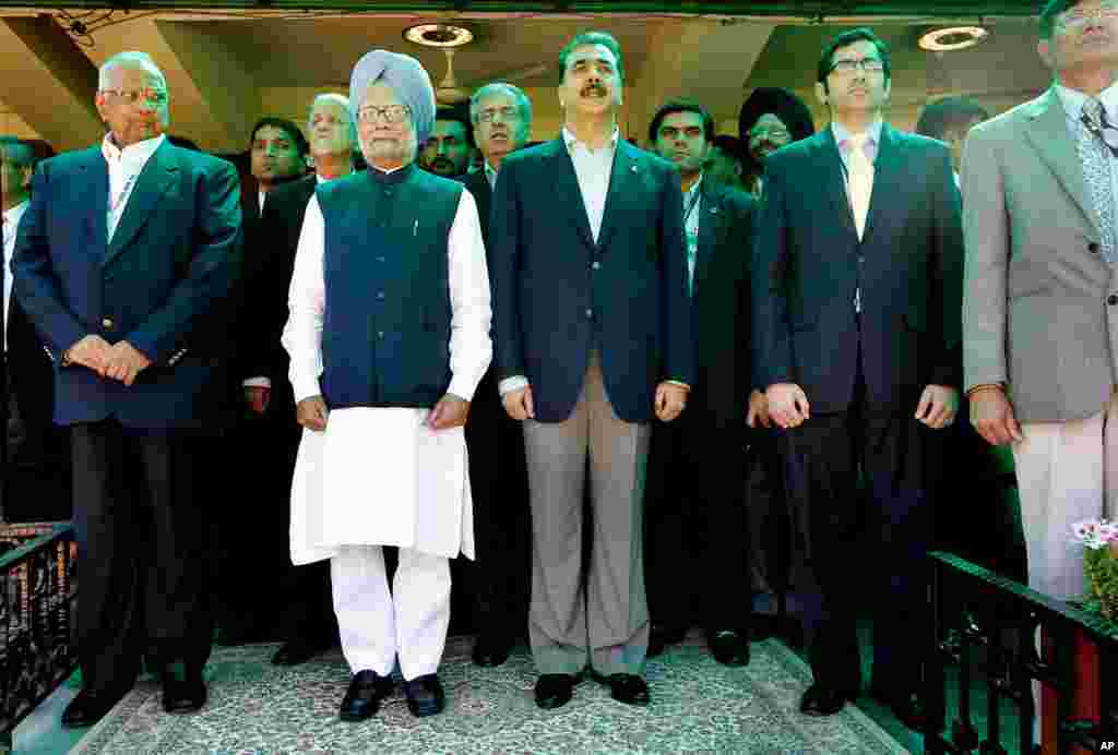 Pakistan's Prime Minister Yusuf Raza Gilani and India's Prime Minister Manmohan Singh stand for national anthems before the World Cup cricket second semi-final between India and Pakistan in Mohali, India March 30, 2011. (Reuters)
