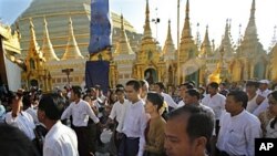 ေဒၚေအာင္ဆန္းစုၾကည္ႏွင့္ သားငယ္ ကုိထိန္လင္း ေရႊတိဂုံေစတီေတာ္သို႔ ေရာက္ရွိလာစဥ္။ ႏုိ၀င္ဘာ ၂၄၊ ၂၀၁၀။