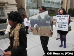 FILE - A coalition of organizations and companies against forced child labor in Uzbekistan's cotton fields holds a rally in Washington, D.C., outside of the Embassy of Uzbekistan, March 11, 2013