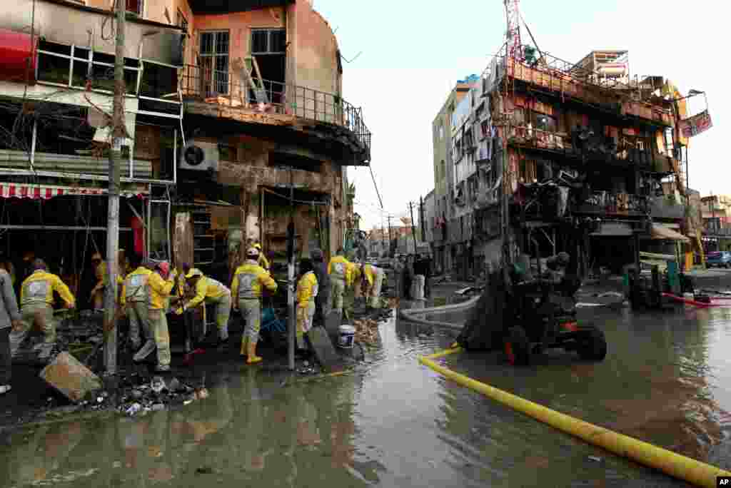 Baghdad municipality workers clean up debris after a car bomb attack, Baghdad, Iraq, Feb. 18, 2014.&nbsp;