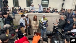 Demonstration leader Khymani James, center right, and other protesters address the media outside a tent camp on the campus of Columbia University in New York on April 24, 2024. 