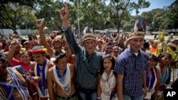 FILE - Lawmaker Romel Guzamana, center, protests with supporters in Caracas, Venezuela, Jan. 13, 2016. Dozens of Indians under the cry of "justice, justice," protested the removal of three Amazonas state elected congress members from the National Assembly. Guzamana is one of three lawmakers who were barred by the Supreme Court from taking office due to irregularities during the election.