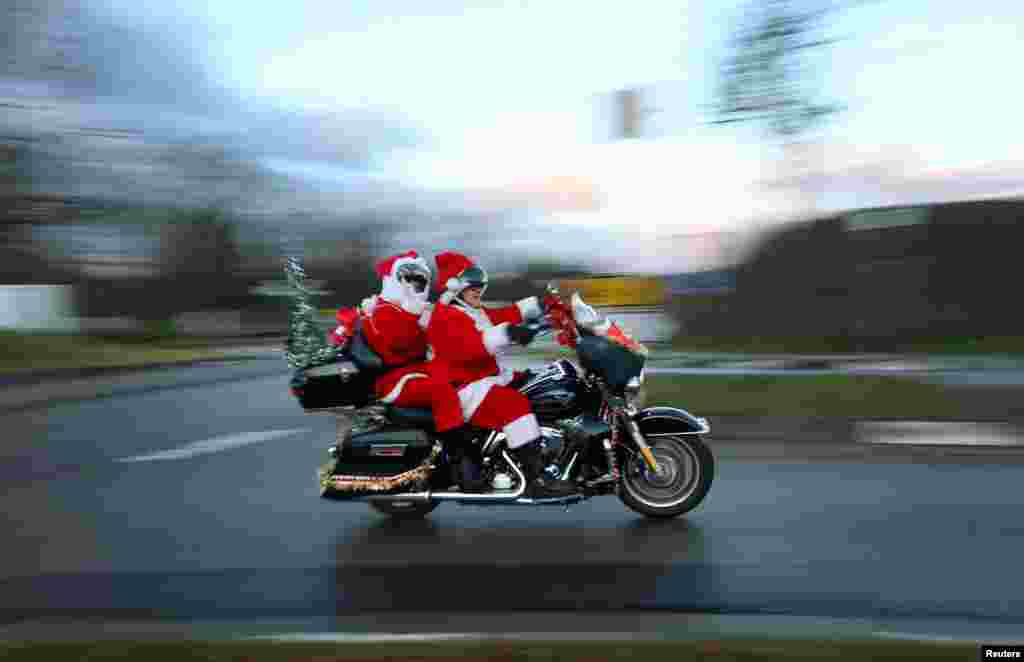 Members of the &quot;Riding Santas&quot; Harley Davidson club take part in their 10th ride to distribute sweets to children and collect money for a children&#39;s hospice in Jockgrim, near Neustadt an der Weinstrasse, Germany.