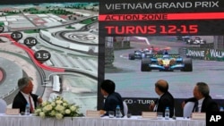 President and CEO of Formula 1 Chase Carey, left, Hanoi Mayor Nguyen Duc Chung, second from left and two other officials watch the Hanoi F1 circuit design on the screen in Hanoi, Vietnam, Wednesday, Nov. 7, 2018. Formula 1 and Hanoi officials on…