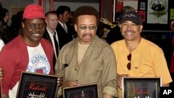 FILE - From left, Philip Bailey, Maurice White and Ralph Johnson of Earth Wind & Fire are inducted at the Hollywood Rock Walk in Los Angeles, July 7, 2003. White died at home in Los Angeles Feb. 3, 2016.
