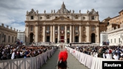 FILE - A Swiss Guard stands on the day Pope Francis attends a mass to canonize fourteen new saints in St. Peter's Square at the Vatican, Oct. 20, 2024. 