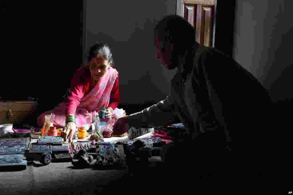 Chitrakar couple Tej Kumari and Purna, right, prepare to make traditional paintings at their residence in Bhaktapur, Nepal, July 31, 2019.