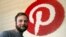 FILE - Pinterest co-founder and chief product officer, poses for a photo beside a wall of pegs symbolizing the company logo at Pinterest headquarters in San Francisco, Oct. 11, 2018. 