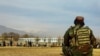 FILE - A Taliban security personnel keeps watch ahead of the court flogging of women and men at a football stadium in Parwan province, Dec. 8, 2022. 