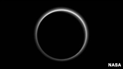 Pluto sends a breathtaking farewell to New Horizons. Backlit by the sun, Pluto’s atmosphere rings its silhouette like a luminous halo in this image taken by NASA’s New Horizons spacecraft around midnight EDT on July 15. (NASA/JHUAPL/SwRI) 