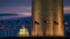 Flags around the Washington Monument fly in the breeze at daybreak, Dec. 31, 2015. Tourism experts fear President Trump's travel ban may hurt tourism across the United States.