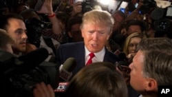 FILE - Republican presidential candidate Donald Trump speaks to reporters after the first Republican presidential debate at the Quicken Loans Arena in Cleveland, Aug. 6, 2015. 