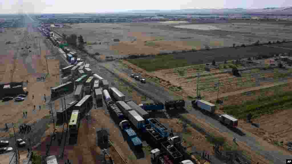 Trucks sit idle on the Pan-American South Highway during a blockade set up by farmworkers, on the fourth day of protests against the Agricultural Promotion Law, in Villacuri, Ica province, Peru.