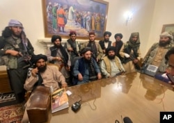 FILE - Taliban fighters take control of Afghanistan's presidential palace after President Ashraf Ghani left the country, in Kabul, Aug. 15, 2021.