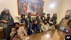 Taliban fighters take control of Afghanistan's presidential palace after President Ashraf Ghani left the country, in Kabul, Afghanistan, Aug. 15, 2021. 