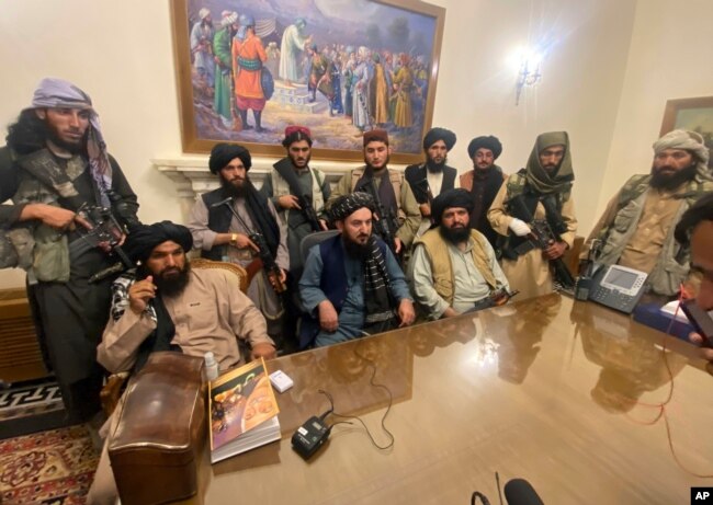 FILE - Taliban fighters take control of Afghanistan's presidential palace after President Ashraf Ghani left the country, in Kabul, Aug. 15, 2021.