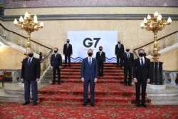 G-7 foreign ministers wear face masks and are socially distanced for a group photo on the stairs at Lancaster House in London ahead of talks at the G7 foreign and development ministers meeting in London, May 4, 2021.
