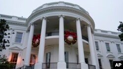 FILE - Wreaths hang on the Truman Balcony of the White House in Washington, Nov. 27, 2022. 