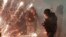 Lebanese riot police run from firecrackers thrown by supporters of the Shiite Hezbollah and Amal Movement groups, who were trying to attack anti-government protesters, in Beirut, Dec. 14, 2019. 