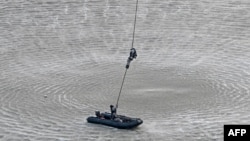 Marine Commandos (MARCOS) of the Indian Navy participates in a simulated hostage rescue operation during the rehearsal for upcoming Navy Day celebrations at the Gateway of India in Mumbai.