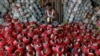 A man polishes an earthen pitcher typically used during Garba, a folk dance, inside a workshop ahead of Navratri, a festival during which devotees worship the Hindu goddess Durga and youths dance in traditional costumes, in Ahmedabad, India.