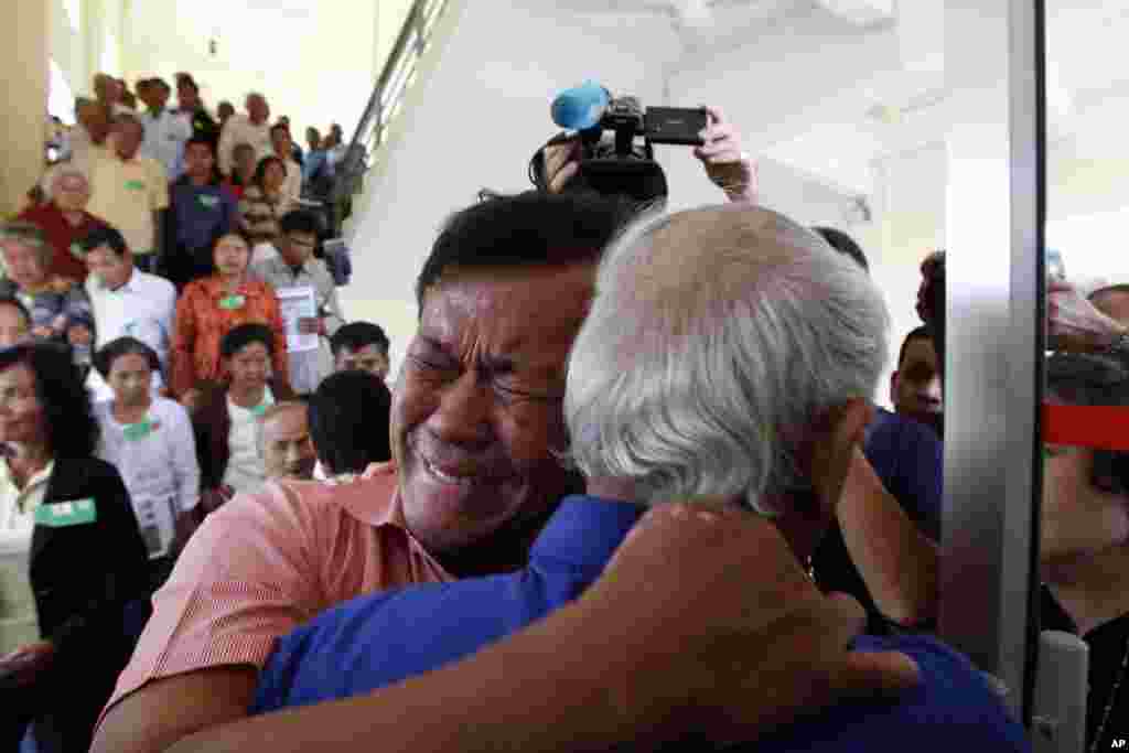 Cambodian former Khmer Rouge survivors, Soum Rithy, left, and Chum Mey, right, embrace each other after the verdicts were announced at the U.N.-backed war crimes tribunal in Phnom Penh. The tribunal sentenced two top leaders of the former regime to life in prison on war crimes charges for their role in the country&#39;s terror period in the 1970s.