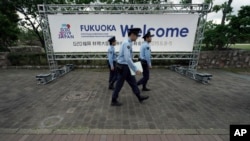 Police officers walk near the venue of G-20 finance ministers and central bank governors meeting, June 7, 2019, in Fukuoka, western Japan.