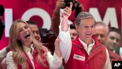 Alfredo Del Mazo, Mexico state gubernatorial candidate for the ruling Institutional Revolutionary Party, or PRI, and his wife Fernanda Castillo greet supporters at the party's headquarters in Toluca, capital of Mexico state, June 4, 2017