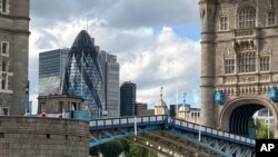 Tower Bridge crossing the River Thames is stuck open, leaving traffic in chaos for a time, in London, Aug. 22, 2020. The problem was solved by midevening, however.