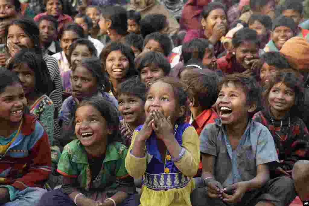 Impoverished Indian children watch a performance that&#39;s part of advocacy against child labor, in Allahabad.