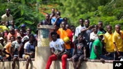 Haitian fans of the Brazil national soccer team watch the Brazil vs. Costa Rica World Cup match broadcast on a television screen in Port-au-Prince, Haiti, June 22, 2018. Brazil won the match 2-0. 