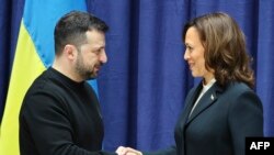 Ukrainian President Volodymyr Zelensky and US Vice President Kamala Harris shake hands at the end of a press conference at the Munich Security Conference (MSC) in Munich, southern Germany on February 17, 2024.