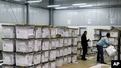 Election officials arrange ballot boxes at a counting center in Kosovo Polje, Dec 13, 2010