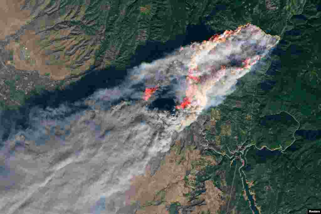 FILE - NASA's Operational Land Imager satellite image shows the Camp Fire burning at around 10:45 a.m. local time near Paradise, California, U.S., on Nov. 8, 2018.