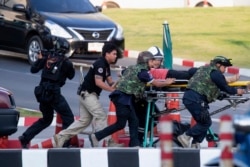 Armed commando soldiers carry a person out of Terminal 21 Korat mall in Nakhon Ratchasima, Thailand, Feb. 9, 2020.