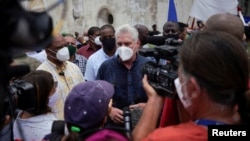 FILE - Cuban President Miguel Diaz-Canel talks to the media, in San Antonio de los Banos, Cuba, July 11, 2021.