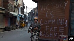 An Indian paramilitary soldier stands guard during curfew in Srinagar, Indian controlled Kashmir, Sept. 13, 2016.