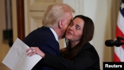 U.S. President Donald Trump greets Laken Riley's mother, Allyson Phillips, during an event to sign the Laken Riley Act at the White House in Washington on Jan. 29, 2025.