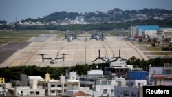 FILE - US Marine Corps MV-22 Osprey aircrafts are seen at the US Marine Corps' Futenma Air Station in Ginowan on Japan's southernmost island of Okinawa, March 24, 2018.