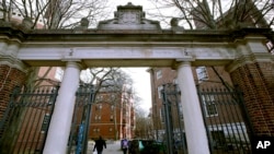 FILE - A gate opens to the Harvard University campus in Cambridge, Massachusetts, Dec. 13, 2018.