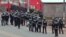 FILE - Cameroon police officials walk with riot shields