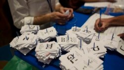 Workers count votes in Israel's national elections, at the Knesset in Jerusalem, Thursday, March 25, 2021.