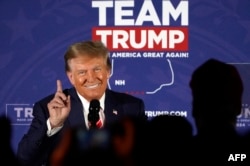 FILE - Republican presidential hopeful and former US President Donald Trump gestures as he speaks during a rally in Laconia, New Hampshire, January 22, 2024.